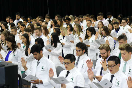 Michigan State University College of Osteopathic Medicine students take the osteopathic pledge. (what is osteopathic medicine?)