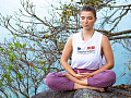 young woman sitting outside in a meditation position