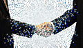 two business men shaking hands showing the energy connecting in both hands and arms